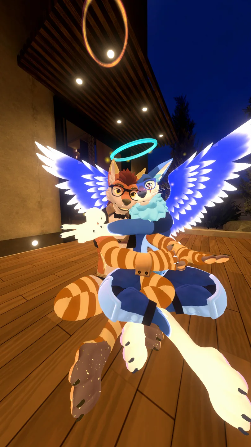 MarshmelloFoxyYT and partner Sammy The Femboy Puppy sitting together with bright blue angel wings in VRChat.